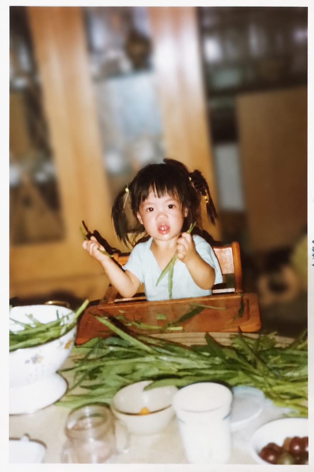 Cynthia as a child at the family table, snapping green beans